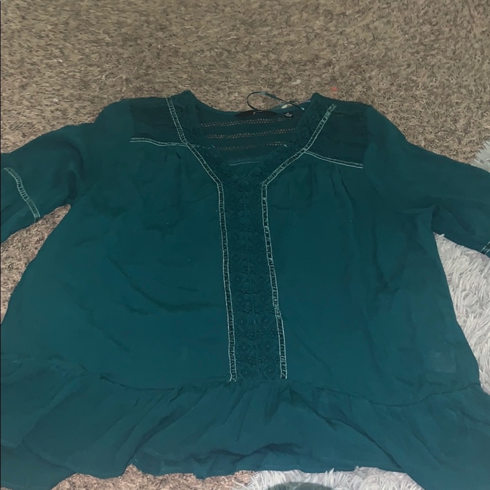 green ruffle bottom blouse